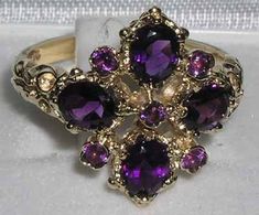 *This ring is made from 585 14K (14ct 14Kt) Yellow Gold with Genuine Natural Amethysts.*Total Height 4mm, Width 15mm, Length 17mm Like all my jewelry pieces, this ring is made in my own workshop. PLEASE MAKE SURE YOU STATE THE FINGER SIZE YOU REQUIRE WITH YOUR PAYMENT AND ALSO INCLUDE YOUR TELEPHONE NUMBER FOR DELIVERY COURIER.This truly elegant English ring has been set with four 5x4mm (0.2"x0.16") oval cut five 2mm (0.8") round cut, Fabulous Deep Purple Amethysts all set in this stunning Solid Regal Rings, Amythest Jewelry, Rhombus Ring, Amethyst Engagement Ring, Amethyst Ring Engagement, Morganite Engagement, Amethyst Jewelry, Victorian Style, Solid Yellow