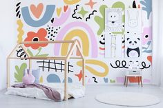 a child's room with colorful wallpaper and wooden bed in the foreground