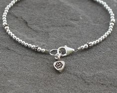 "A single strand of 2.5mm to 3mm sterling silver beads are paired with Turkish silver accents and a coordinating Thai fine silver heart charm. Finished with a secure sterling silver lobster clasp. This bracelet is sweet and dainty and would be lovely worn by itself or layered with other bracelets. The perfect everyday piece. Total length measures 7 1/2\". Sterling silver is .925 pure silver. Turkish silver is .925 pure silver. Fine silver is .95 to .99 pure silver. Check out other items in my sh Green Amethyst Earrings, Bracelet With Heart, Silver Beaded Bracelet, Sterling Silver Bead Bracelet, Cleaning Silver Jewelry, Love Jewelry, Silver Bead Bracelet, Turkish Jewelry, Jewellery Ideas