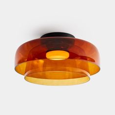 an orange and black light fixture hanging from the ceiling