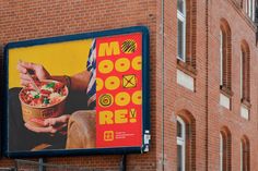 a large sign on the side of a building advertising food and beverage items for mcdonald's