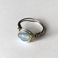 White Opal Ring Wire Wrapped in Stainless Steel Wire – Kelly Mae Kreations Adjustable Spiritual Birthstone Jewelry, Spiritual Adjustable Birthstone Jewelry, Spiritual Birthstone Gemstone Ring, Nickel-free White Spiritual Jewelry, Adjustable White Opal Jewelry, Spiritual Nickel-free White Jewelry, Spiritual White Nickel-free Jewelry, Adjustable Silver Opal Ring For Healing, Adjustable Spiritual Moonstone Promise Ring