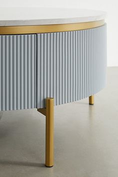 a blue and gold sideboard with two wooden legs