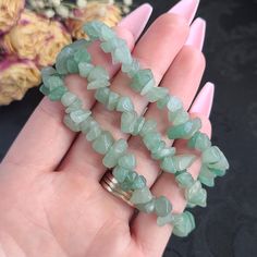 "**These bracelets are already made, so we are not able to customize sizes. Please verify your wrist size before ordering.** To see our other crystal Bracelets, click here: https://www.etsy.com/shop/BeautifulVibeCrystal?section_id=36836813 Approximate Dimensions: Bead: 5 - 8 mm Chip/Nugget Bracelet Fits: 6 - 7.5\" Wrist 1 inch = 25.4 mm 1 pound = 453.6 grams Aventurine is known as the \"Stone of Opportunity,\" and is believed to be the luckiest of all crystals. It can be especially useful in man Crystal Bracelet Collection, Chipped Crystal Bracelet, Green Crystal Bracelet, Green Crystal Beaded Bracelets, Handmade Green Crystal Bracelet For Party, Aventurine Bracelet, Aventurine Gemstone Crystal Bracelet Gift, Handmade Aventurine Crystal Bracelet Gift, Handmade Green Crystal Bracelets