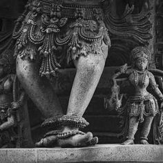 the legs and feet of two statues in black and white