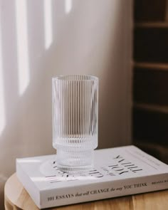 a clear glass sitting on top of a book