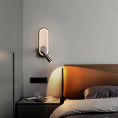 a bed that has a light on the side of it