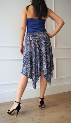 "Add a touch of elegance to your summer clothing collection with our patterned skirt, entirely handmade. The skirt features a longer tail at the back and a shorter cut in the front, with an elastic waistband for a comfortable and snug fit. Made with high-quality, Italian fluid jersey fabric, the skirt is perfect for tango, milonga, and also for a day-time look. Buy your unique and versatile summer skirt today! Size: S-M Front length: 56 cm Back length: 86 cm Waist circumference: 66-72 cm The mod Elegant Summer Gathered Wrap Skirt, Fitted Summer Wrap Skirt Pleated, Fitted Pleated Wrap Skirt For Summer, Fitted Tiered Wrap Skirt For Summer, Fitted Lined Maxi Skirt For Summer, Fitted Summer Wrap Skirt With Gathered Detail, Fitted Flared Wrap Skirt For Beach, Fitted Lined Tiered Wrap Skirt, Fitted Tiered Wrap Skirt With Lining