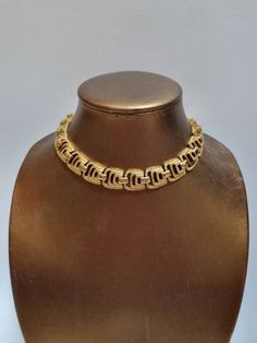 A beautifully designed and crafted 1960s necklace by Monet, in excellent vintage condition, Signed Monet, on a metal hangtag attached to the chain.  The shortest length is 37cm, and the longest is 41cm. The width is 1.6cm. All jewellery is sanitised and ready to wear.  We have lots more fabulous Monet necklaces for sale in our shop :) ------------------ 🏆About the Designer: Vintage Monet jewellery is prized by collectors because of its high quality and design. The triple-plating manufacturing process ensures that Monet jewellery lasts for decades without tarnish. In the 80s and 90s, Monet produced jewellery for Yves Saint Laurent and Christian Lacroix. -------------------- 🌟 P&P: 👉 Will arrive gift wrapped, in a padded bag 👉 UK shipping: Royal Mail Tracked 24 👉 International Shipping: Retro Metal Necklace With Adjustable Chain, Retro Yellow Gold Metal Jewelry, Retro Metal Necklaces With Adjustable Chain, Vintage Metal Choker For Formal Occasions, Formal Vintage Metal Choker, Vintage Brass Choker Necklace, Retro Gold Jewelry With Adjustable Chain, Retro Metal Clavicle Chain Necklace, Gold Hallmarked Necklaces For Evening