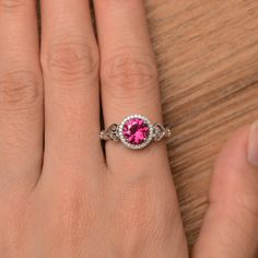 It is a pretty lab ruby ring, the round cut ruby is about 7mm*7mm, weight about 1.66 carats. The basic metal is sterling silver and plated with rhodium. To change the metal to a solid gold (white/rose) or platinum is also available, please ask for a quotation if you want. You can also go to my shop Home for more elegant rings: https://www.etsy.com/shop/godjewelry?ref=hdr_shop_menu Ruby is the birthstone of July, it will be a great gift for your lover! More ruby rings: https://www.etsy.com/shop/g Ruby Ring Engagement, Rubin Ring, Round Cut Ring, Red Gemstone Ring, Ruby Engagement Ring, Red Gemstones, Halo Engagement Rings, July Birthstone, Elegant Ring