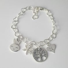 Personalized charm bracelet + Sterling silver heart (5.3 mm) bracelet with lobster clasp (can be adjusted upto 7 inch) + Sterling silver tree charm (15mm) + Sterling silver heart blank (10mm) + Sterling silver bunny charm (10x16mm) + Sterling silver dragonfly with CZ charm (10x12mm) + If you would like metal stamping on them, just write in the message box which letter you would like on the heart blank charm * Every item comes in a pretty gift box * I can also make it with other charms in my shop Silver Heart Charm Bracelet For Friendship, Hypoallergenic Charm Bracelet For Birthday, Silver Name Bracelet With Heart Charm For Gift, Silver Name Bracelet With Heart Charm As Gift, Silver Name Bracelet With Heart Charm, Personalized Silver Charm Bracelet For Gift, Silver Nickel-free Heart Bracelet For Friendship, Gift Charm Bracelet With Dangling Charms, Sterling Silver Charm Bracelet With Dangling Charms As Gift