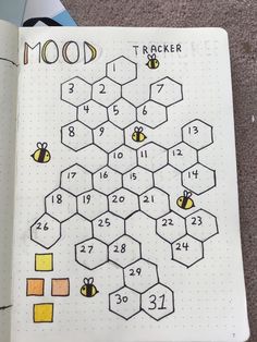 an open notebook with bees and numbers on it