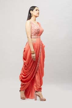 Modern, fun and chic! This readymade coral dhoti saree with multi-resham embroidery is perfect for any bridal event! Fabric: Satin silk Ready to Ship Occasion: Sangeet, Mehendi Events WASH CARE INSTRUCTIONS - Please Dry clean only when it is applicable. Slight color variation is possible due to digital photography. Jewelry not included Embroidered Draped Lehenga For Wedding, Embroidered Draped Traditional Wear For Diwali, Embroidered Draped Traditional Wear For Wedding, Embroidered Draped Traditional Wedding Wear, Embroidered Draped Dupatta For Diwali, Traditional Draped Wear With Resham Embroidery For Eid, Designer Wear Draped Sharara With Resham Embroidery, Traditional Chanderi Draped Dupatta, Traditional Pink Draped Lehenga