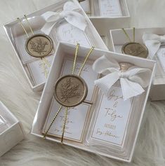 four white boxes with tags and bows on them