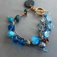 Czech glass Blue and gold boho bracelet with Aquamarine nuggets,  Blue Agates, chevron bead , cloisonne bead with gold chain and toggle Chevron Beads, Bracelet Blue, Boho Bracelet, Asheville Nc, Blue Agate, Blue Bracelet, Blue And Gold, Boho Bracelets, Asheville