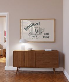 an empty room with a wooden sideboard in the corner and a painting on the wall