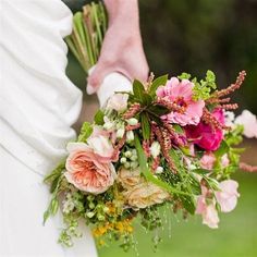 a bride holding a bouquet of flowers in her hand