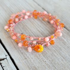 "Pink and Orange gemmy boho beaded crochet bracelet wrap...made in Hawaii and ready to ship! Grab your 15% off code now by signing up to my VIP group here: http://eepurl.com/c5riDL ↓ more details below on this bracelet * carnelian, pink coral, sunstone, rhodocrisite, crystals, silverite * nylon bead cord * orange coral button clasp * 14k gold fill wire beaded charm A Hawaii sunrise mix of randomly placed pink and orange gems and crystals with:  carnelian, pink coral, sunstone, pink rhodocrisite Orange Gem, Pink Dye, Crochet Beaded Bracelets, Boho Wrap Bracelet, Beaded Crochet, Unique Jewelry Gifts, Vip Group, Orange Coral, Crochet Bracelet