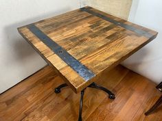 a wooden table sitting on top of a hard wood floor