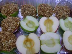 some apples are cut in half and ready to be eaten with crumbs on them