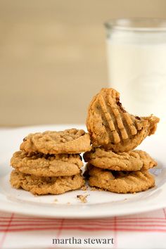 cookies stacked on top of each other with a glass of milk in the background