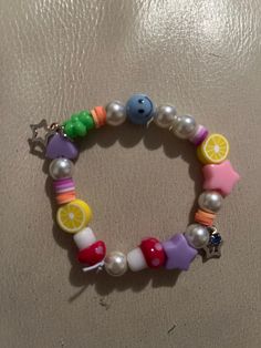 Stretchy beaded bracelet. Pony, mushroom, lemon and smiley face beads. Fits small or medium sized wrists. Smiley Face Beads, Stretchy Beaded Bracelet, Sally Face, Hotel Art, Smiley Face, Beaded Bracelet, Smiley, Jewelry Bracelets, Lemon