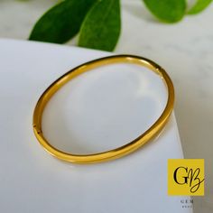 Introducing our Classic Gold Bracelet. This is a simple gold plated 14k hinged bangle which is a timeless piece. This trendy bracelet will bring a minimalist, modern and fashion touch to your look. Elegant and simple in its design and therefore such a favourite piece. Crafted from high-quality stainless steel, this bangle is built to last. The gold plating not only enhances its aesthetic appeal but also adds a luxurious touch, exuding a radiant glow that catches the eye. The combination of stain Gold Hoop Bangle In Minimalist Style, Minimalist Gold Hoop Bangle, Minimalist Gold Plated Round Bangle, Minimalist Gold Plated Bangle, Classic Gold Hinged Bangle, Gold Tarnish Resistant Hoop Bracelets, Minimalist Yellow Gold-plated Bangle, Tarnish Resistant Hoop Gold Bracelets, Minimalist Yellow Gold Plated Bangle