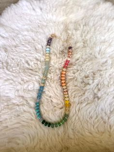 This rainbow inspired necklace is all about fun vibes, with a gradient of colors that flow from cool blues and greens to warm oranges, yellows, and soft pastels. Each semi-precious stone is strung together to create a unique, cheerful piece to add to your collection! This necklace is perfect for anyone looking to add a pop of color and a bit of playful charm to their everyday style! Features • Semi Precious Gemstones • Glass Seed Beads • Gold plated brass clasp and extender • Measures 16” plus a Bohemian Rainbow Crystal Necklaces With Colorful Beads, Bohemian Rainbow Crystal Necklaces With Faceted Beads, Bohemian Rainbow Crystal Necklace With Colorful Beads, Bohemian Rainbow Crystal Necklace With Faceted Beads, Adjustable Rainbow Crystal Bohemian Necklaces, Adjustable Rainbow Crystal Bohemian Necklace, Adjustable Rainbow Crystal Necklace With Faceted Beads, Adjustable Rainbow Bohemian Crystal Necklace, Rainbow Faceted Beads Necklace For Gift