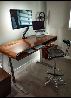 a computer desk with a laptop on top of it and a chair in front of it