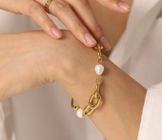 Gold plated mother of pearls bracelet. Beautifully made with 2 inch extender. Gold Bangle Bracelet With Pearl Drop, Gold Metal Pearl Bracelet With Jubilee Design, Adjustable Gold Metal Pearl Bracelet, Gold Pearl Charm Bangle Bracelet, Adjustable Gold Bracelets With Pearl Drop, Metal Pearl Bracelet With Pearl Charm, Gold Pearl Bracelet With Oyster Detail, Gold Pearl Drop Bangle Jewelry, Elegant Gold Charm Bracelet With Pearl