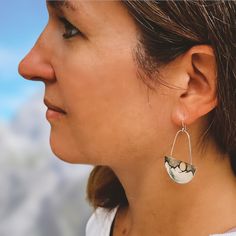 You will love these mixed metal, high-contrast mountain, and moon earrings. The moon is 14K gold and really pops against the black silver in the night sky. The mountains are very contemporary without any texture and the black-silver sky adds a beautiful contrast to the gold and tarnish-resistant Argentium sterling silver. Details: length- approximately 1 1/4” wide x 1 5/8” long Material(s)- solid Argentium sterling silver and 14K gold Argentium sterling silver French ear wire (Argentium is also Elegant Half Moon Metal Earrings, Elegant Semi-circle Metal Earrings, Elegant Crescent Jewelry With Oxidized Finish, Elegant Silver Moon-shaped Jewelry, Elegant Crescent Oxidized Jewelry, Elegant Silver Moon Jewelry, Elegant Semi-circle Metal Jewelry, Silver Moon-shaped Metal Hoop Earrings, Sterling Silver Half Moon Pierced Jewelry