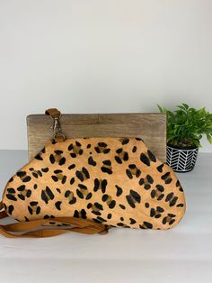 Genuine leather Leopard print clutch with long strap. Wooden handle 9 inches in length. Brown Clutch With Removable Pouch For On-the-go, Brown Travel Clutch With Detachable Strap, Trendy Leather Clutch With Top Carry Handle, Brown Clutch With Leather Handles For Daily Use, Brown Leather Handle Clutch For Daily Use, Handheld Clutch With Detachable Strap For Travel, Brown Crossbody Clutch With Removable Pouch, Brown Crossbody Clutch For Daily Use, Everyday Pouch Clutch With Top Handle