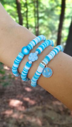 This super cute clay bead bracelet is made with high quality beads. It has a randomized pattern with the colors: -blue -light blue -white The first bracelet to choose from has a gradient heart bead in the center. The second bracelet has a blue flower bead with 2 pearl beads. lastly, you can choose a dangling blue smiley face. Like this design but want a differnt charm? Check out the rest of my Etsy store to find this same bracelet design but with differnt charms. Please note that colors and pattern may vary from each bracelet. All bracelets vary from 6.5 inches to 6.75 inches.  While the string I use is high quality, be careful not to overstretch the bracelet as it will shorten its lifespan. In addition, keep out of water as it will shorten the lifespan of the bracelet. Excessive sweating Blue Clay Bead Bracelets, Heart Smiley Face, Sea Beads, Gradient Heart, Heart Smiley, Make Clay Beads, Clay Bead Bracelet, Crystal Bead Jewelry, Bracelet With Heart