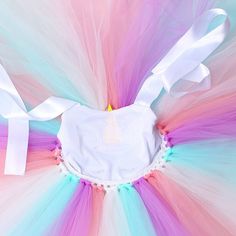 an image of a colorful tutu skirt with white ribbon around it's waist