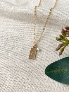 dainty initial necklace, gift for mom, dainty gold necklace, letter necklace, gift for her, stocking stuffer, holiday gift for her, jewelry gift for her Details: This necklace can be personalized for yourself or to give as a thoughtful gift! Each adorable tiny rectangle charm is hand stamped with the initial of your choice. This makes a gorgeous simple and meaningful every day necklace. * Tiny 14K Gold Filled or 925 Sterling Silver 13x6mm rectangle tag charm * Freshwater pearl charm (removable u Dainty Initial Necklace, Custom Initial Necklace, Dainty Gold Necklace, Monogram Necklace, Keepsake Jewelry, Vermeil Jewelry, Personalized Gifts For Her, Pearl Charms, Letter Necklace