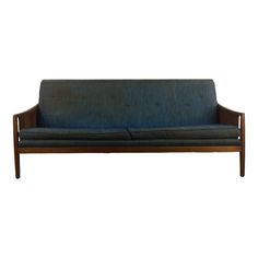 a blue couch sitting on top of a wooden frame