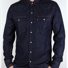 A Must Have Item For Anyone Who Needs That One Item That Can Be Thrown On And Away You Go. The Levis Denim Shirt In A Dark Denim Features Classic Styling Ques With Its Stud Popper Fastening, Twin Chest Pocket Details And Light Coloured Stitching That Contrasts Against The Dark Denim Coloured Shirt. The All Important Levis Red, Tab Logo Appears On The Upper Pocket. Made From 100% Cotton. Casual Fitted Medium Wash Shirt, Fitted Dark Wash Shirt For Summer, Fitted Dark Wash Denim Shirt, Classic Dark Wash Tops With Pockets, Fitted Denim Shirt With Button Closure, Fitted Dark Wash Collared Shirt, Dark Wash Slim Fit Long Sleeve Shirt, Fitted Button-up Dark Wash Shirt, Classic Dark Wash Collared Tops