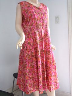 "VINTAGE 1970s HOME SEWN  Fit + Flare PINK FLORAL dress in a size Large to Extra Large.   Super soft and light fabric in an all over floral pattern in pinks, oranges, browns and white.   V-Neck and Back with a 9.5\" partial metal side zipper.  Perfect frock with pleats on the skirt ideal for some dancing and cocktails!! Measurements laying flat: -across the top 16\" -across the bust  20\" -across the waist  17.5\"  -shoulder to waist 16\" -across shoulder strap 3 1/8\" -top to bottom 42.5\" Stalk us on instagram: @outofthepastclothing Stay in touch through FACEBOOK: outofthepastclothing Thousands of stylish and satisfied customers served since 1993. Questions?  Just ask us! And thanks very much for taking the time to visit our listings!" Spring Sleeveless Pink Vintage Dress, Vintage Pink A-line Dress, Pink Sleeveless Vintage Dress For Spring, Spring Vintage Sleeveless Pink Dress, Spring Pink Sleeveless Vintage Dress, 1970s Style Pink Summer Dress, Retro Pink Vintage Dress For Daywear, Pink 1970s Style Summer Dresses, Pink 1970s Summer Dress