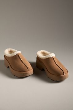 Suede upper Upcycled wool, lyocell insole EVA sole Slip-on styling Imported | New Heights Cozy Clogs by UGG in Beige, Women's, Size: 9, Wool/Lyocell/EVA at Anthropologie Winter Suede Clogs With Rubber Sole, Comfortable Textured Clogs For Fall, Winter Comfortable Closed Toe Clogs, Comfortable Closed Toe Winter Clogs, Cozy Winter Slip-on Clogs, Winter Suede Clogs With Textured Footbed, Winter Closed Toe Clogs With Textured Footbed, Winter Suede Mules With Rubber Sole, Comfortable Winter Clogs With Textured Footbed