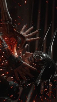 an image of a woman with fire in her face and hands over her head, surrounded by sparks