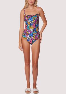 ELIGIBLE FOR RETURNS OR EXCHANGES Start your vacation with a beach view in the Renoir's Terrace Ruffle One-Piece Swimsuit! This floral inspired pattern is featured in an array of spring colors to bring charisma as you dip your toes into the sand. The bust features a a small ruffle trim and sweet bow for a feminine touch. Adjustable strap tie details are found at the shoulder for better support! Style # WMKC09047 Imported 80% Nylon, 20% Spandex Model is 5 ft 9 inches; Bust: 32", Waist: 23.5", Hip