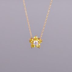 A dainty and beautiful flower pendant with .20 carats of yellow sapphires and a .11 carat diamond center. All set in 14k yellow gold. Dimensions are 9.6mm x 9.4mm Yellow Flower Shaped Jewelry For Anniversary, Yellow Flower-shaped Jewelry For Anniversary, Dainty Yellow Flower Shaped Jewelry, Yellow Flower Pendant Jewelry For Wedding, Yellow Flower Jewelry For Anniversary, Elegant Yellow Jewelry With Flower Charm, Elegant Yellow Flower Pendant Necklace, Yellow Flower Pendant Necklace For Weddings, Dainty Yellow Flower Pendant Jewelry