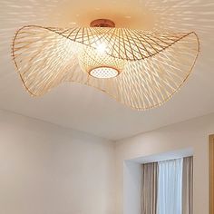 a living room with white walls and a ceiling light that is shaped like a fish