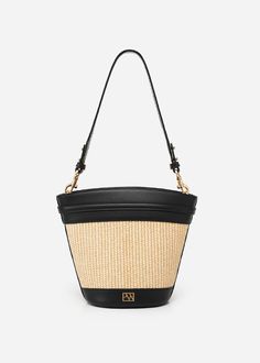 The timeless and trend-setting design of the Madison Bucket Bag is a must-have. It can be worn by its adjustable, removable shoulder strap or elegantly draped over your shoulder with an alternative woven strap. With its spacious interior, it's a wardrobe staple for your everyday adventures. Elegant Woven Shoulder Bag, Elegant Bags With Braided Handles For Spring, Modern Leather Bucket Straw Bag, Modern Leather Straw Bucket Bag, Elegant Woven Leather Hobo Crossbody Bag, Elegant Woven Leather Crossbody Hobo Bag, Elegant Woven Bucket Bag, Luxury Spring Satchel With Adjustable Strap, Elegant Woven Tote Shoulder Bag