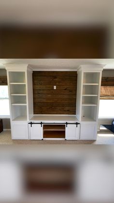 an empty entertainment center with built - in shelving units