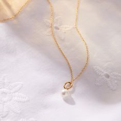 The Pearl Mini Charm Necklace embodies timeless elegance and the precious bond between mother and child. Just as a pearl grows in beauty over time, it serves as a graceful reminder of the love that strengthens with each passing moment. Wear it alone or layer it with your favorite Tiny Tags necklace for a look that’s both meaningful and chic. available in gold vermeil and sterling silver genuine pearl is 7mm hangs on diamond cut chain. View our necklace size guide here. Timeless Gold Pearl Necklace As A Gift, Classic Pearl Pendant Charm Necklace As Gift, Classic Pearl Pendant Charm Necklace For Gift, Classic Charm Necklace With Pearl Pendant For Gift, Elegant Pearl Charm Necklaces As A Gift, Elegant Pearl Chain Charm Necklace As Gift, Elegant Pearl Charm Necklace Gift, Minimalist Pearl Drop Jewelry For Mother's Day, Timeless Pearl Necklace With Charm For Anniversary