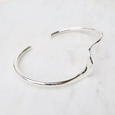 Sterling Silver Cuff with Single Wave The cuff bracelet is an eternal classic and a must-have for every jewelry collection. Stack them, combine plain with texture, mix with stone bracelets, the possibilities are endless. Bright Sterling Silver Approx. 1.9" x 2.5" inner dimensions Handmade in Thailand - Handpicked in Person by our Buyers Modern Adjustable Bangle With Polished Finish, Modern Twist Cuff Bangle For Everyday, Modern Twist Polished Bangle Cuff Bracelet, Modern Adjustable Sterling Silver Cuff Bracelet, Modern Stackable Adjustable Cuff Bracelet, Modern Adjustable Stackable Cuff Bracelet, Adjustable Modern Twist Cuff Bangle Bracelet, Adjustable Open Cuff Bracelet With Polished Finish, Adjustable Open Cuff Bracelets With Polished Finish