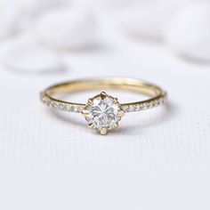 a gold ring with a diamond set in the middle