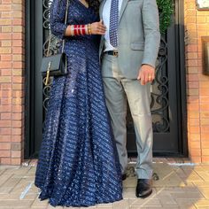 a man and woman standing next to each other in front of a door