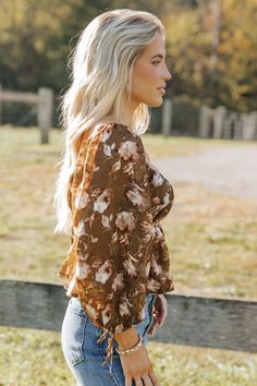 Embrace boho-chic vibes with the Olive Multi Floral Print Blouse, perfect for adding a touch of romance to any outfit! Features 3/4 sleeve length with delicate tie cuffs for a feminine flair. Designed with a square neckline and an elastic waistband for a flattering silhouette. The flowy hem creates a graceful movement, making it a versatile piece for day or night. Pair it with your favorite jeans or a skirt for an effortlessly stylish look. Spring Bohemian Blouse With Square Neck, Flowy Brown Blouse For Spring, Feminine Brown Blouse For Spring, Spring Bohemian Square Neck Blouse, Bohemian Square Neck Blouse For Spring, Brown Square Neck Top For Spring, Elegant Brown Blouse For Brunch, Flowy Fall Blouse With 3/4 Sleeves, Bell Sleeve Blouse For Day Out In Fall